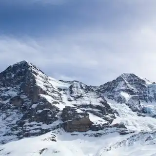 Snow covered mountain under blue sky during daytime — Kleine Scheidegg, Switzerland