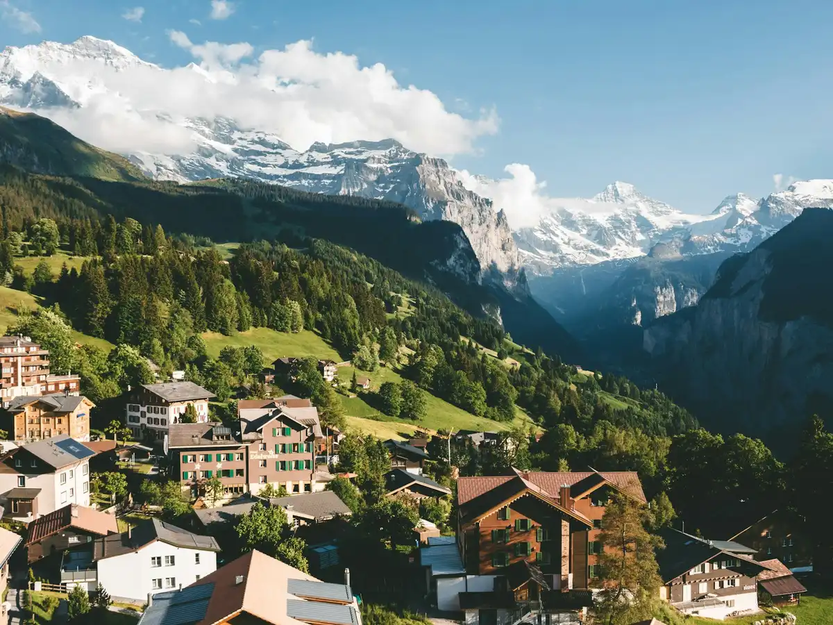 Brown and white houses on green mountain under blue sky during daytime — Wengen, Switzerland