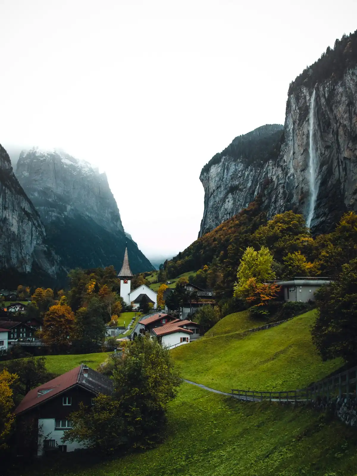 Brown and white house near mountain during daytime — Lauterbrunnen, Switzerland