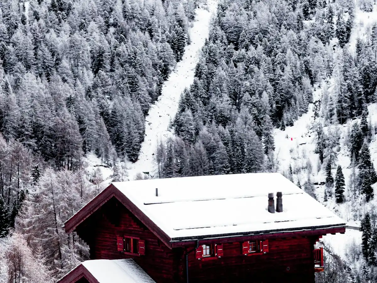 Red wooden house near snow covered mountain — Swiss chalet in winter, Switzerland
