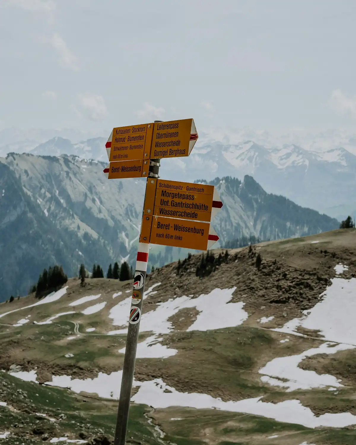 A couple of signs on top of a snow covered hill — Swiss trail sign, Switzerland