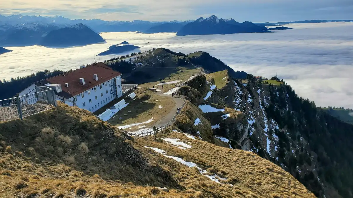 A house on top of a mountain surrounded by clouds — Above the clouds, Switzerland