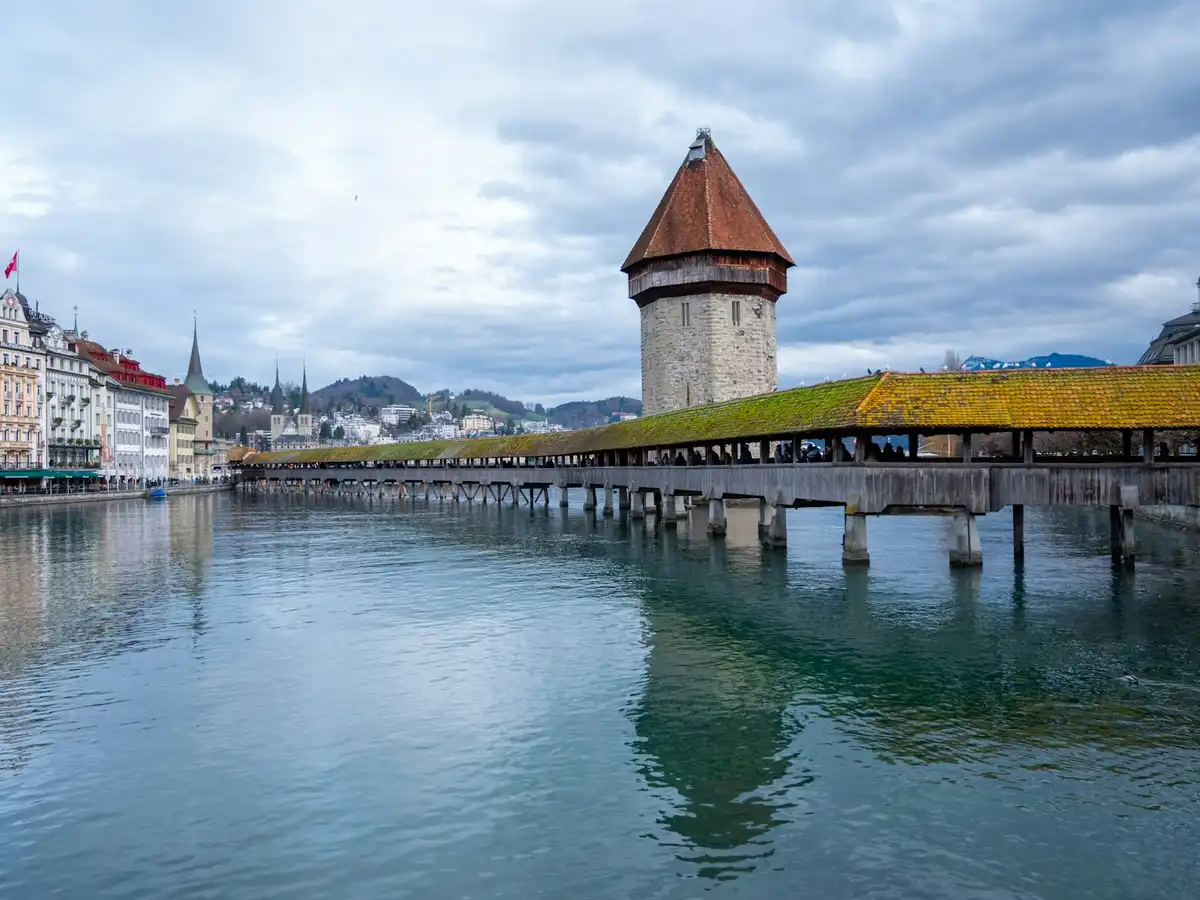 A large body of water next to a tall building — Lucerne, Switzerland