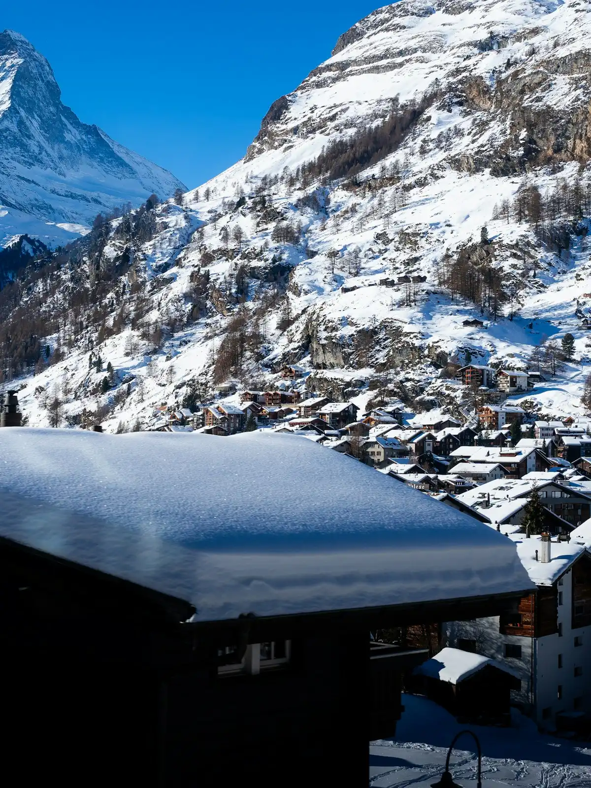 A snow covered mountain with a village in the foreground — Zermatt, Switzerland